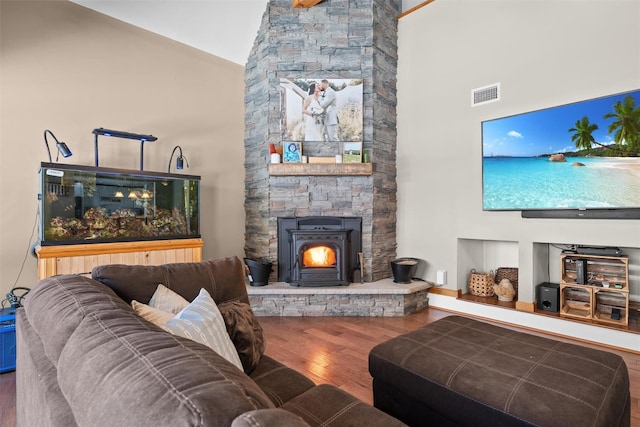 living room featuring wood-type flooring and high vaulted ceiling