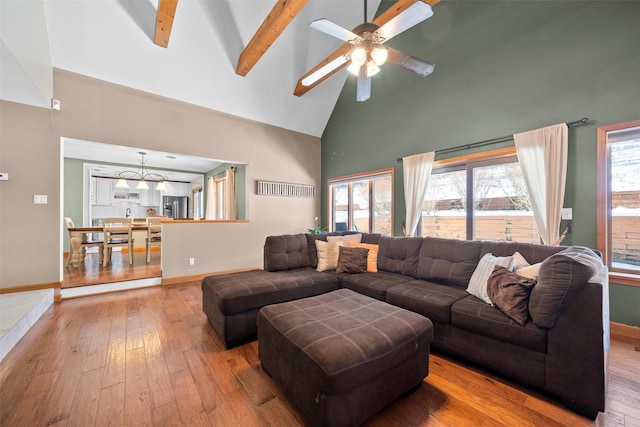 living room featuring hardwood / wood-style flooring, plenty of natural light, high vaulted ceiling, and beamed ceiling