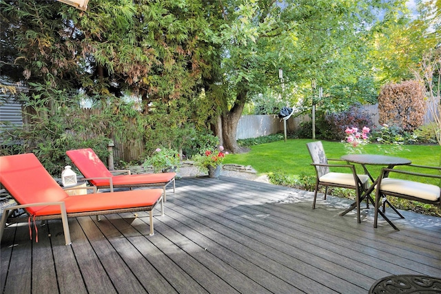 wooden terrace with a lawn