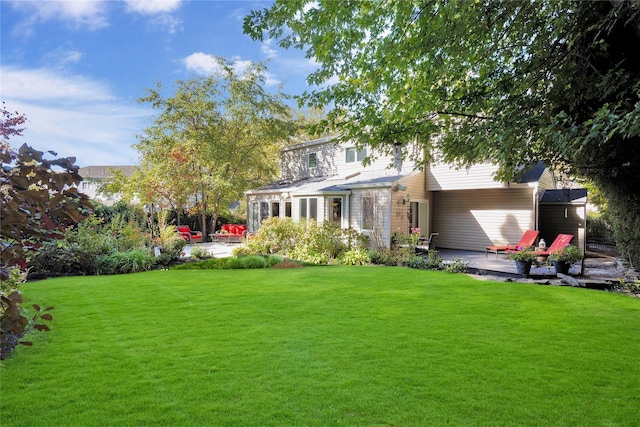 view of front of property with a front yard and a patio