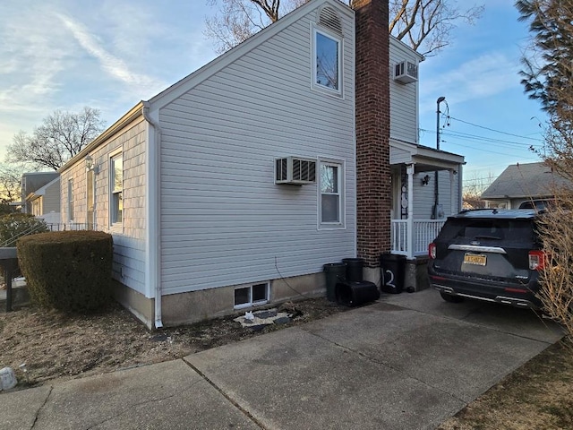 view of property exterior featuring a wall mounted AC