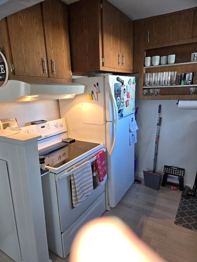 kitchen featuring light hardwood / wood-style flooring and white range with electric cooktop