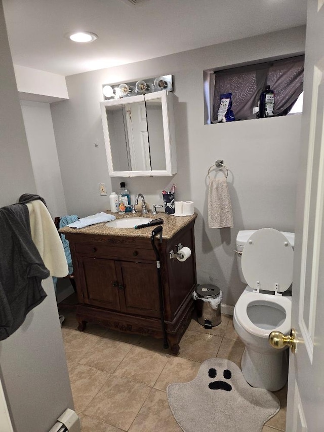 bathroom featuring vanity, tile patterned floors, and toilet