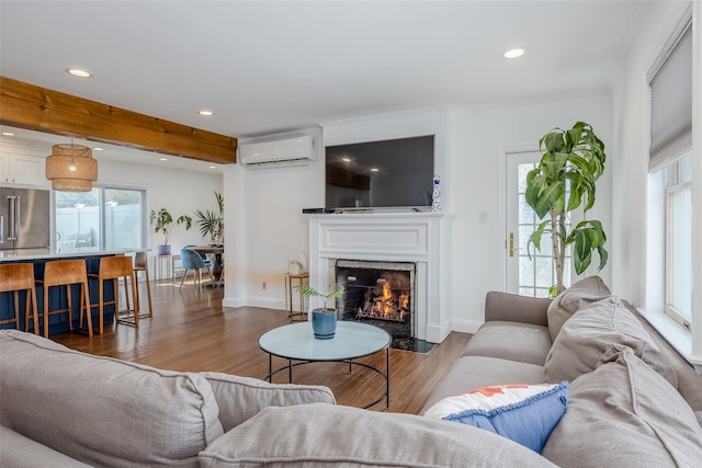 living room featuring a wall mounted air conditioner and dark hardwood / wood-style flooring