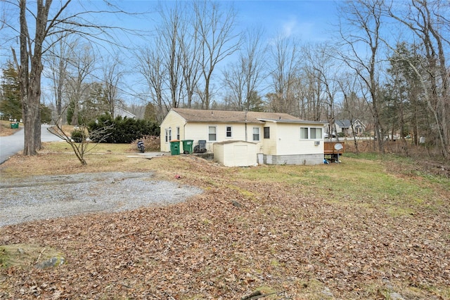 rear view of house featuring a lawn