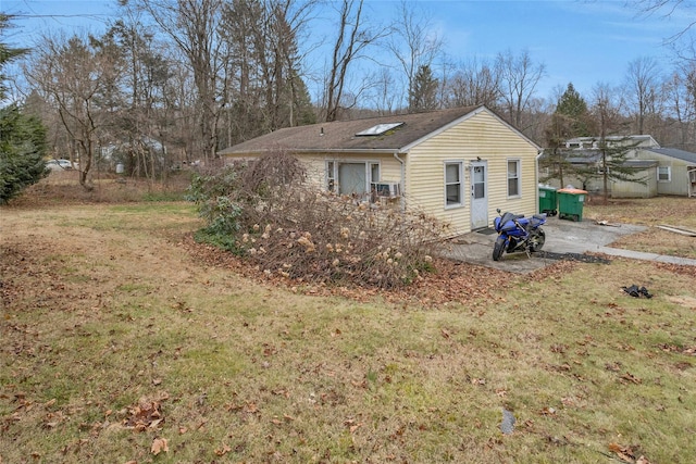 rear view of house with a patio area and a lawn