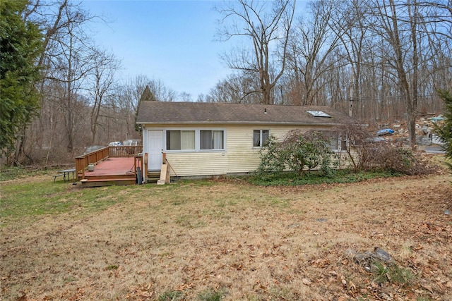 exterior space featuring a deck and a lawn