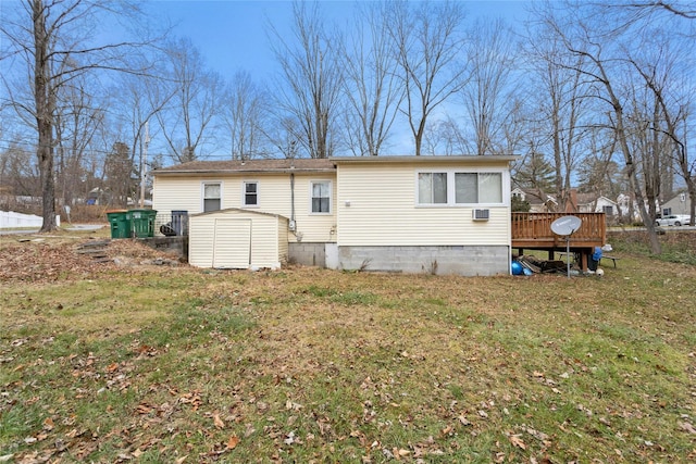 back of house featuring a deck and a lawn