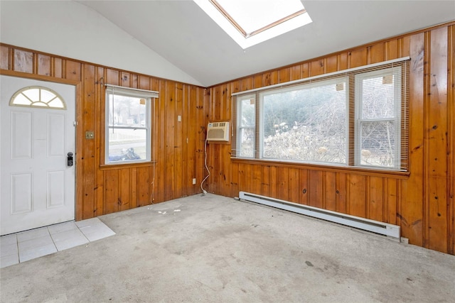 foyer entrance with light carpet, a baseboard heating unit, vaulted ceiling with skylight, and a wall unit AC