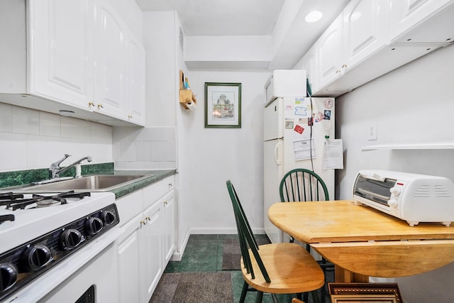 kitchen featuring backsplash, white appliances, sink, and white cabinets