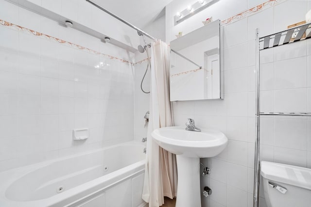 full bathroom with shower / tub combo with curtain, toilet, sink, and tile walls