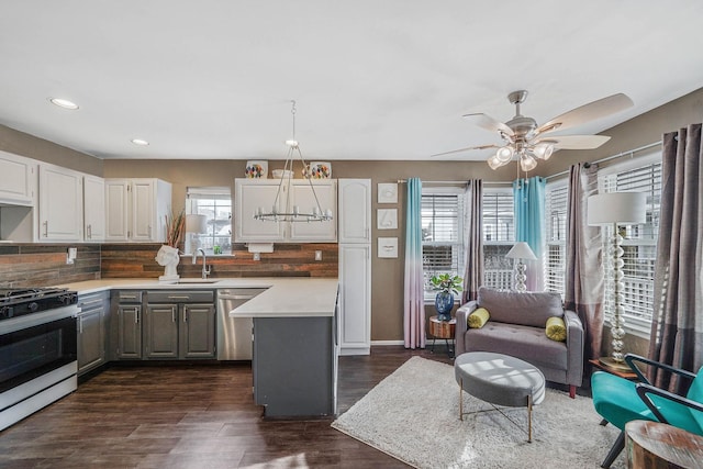 kitchen featuring tasteful backsplash, sink, white cabinets, a center island, and stainless steel appliances