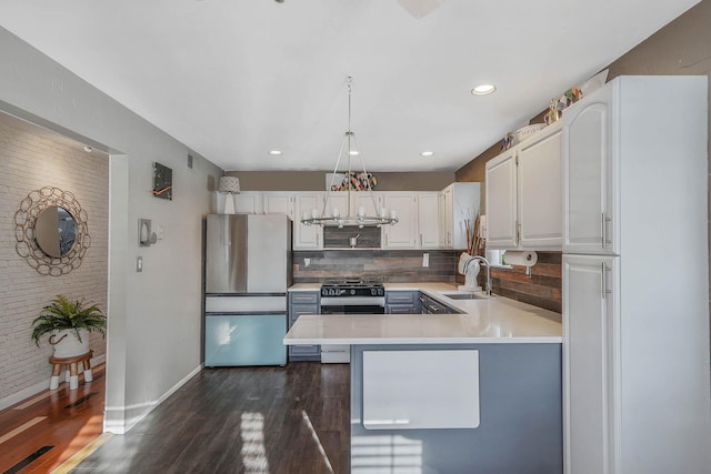 kitchen featuring sink, white cabinetry, stainless steel appliances, tasteful backsplash, and dark hardwood / wood-style flooring