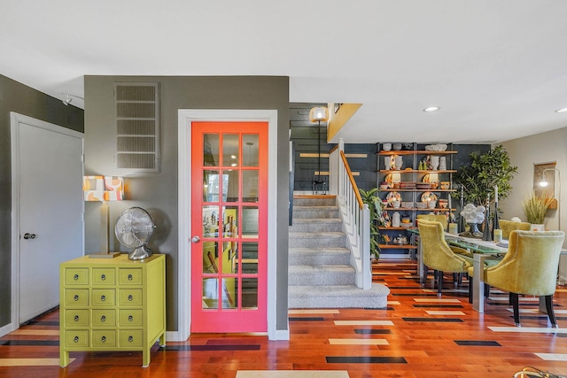 stairs featuring hardwood / wood-style floors