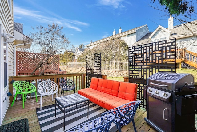 wooden terrace featuring area for grilling and an outdoor hangout area