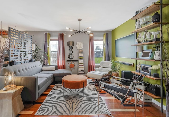 living room featuring hardwood / wood-style floors, a notable chandelier, and a healthy amount of sunlight