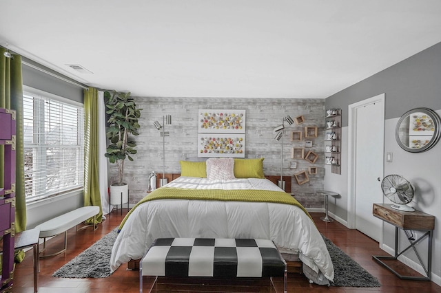 bedroom featuring wooden walls and dark hardwood / wood-style flooring