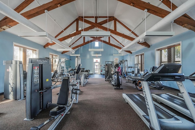 workout area featuring high vaulted ceiling