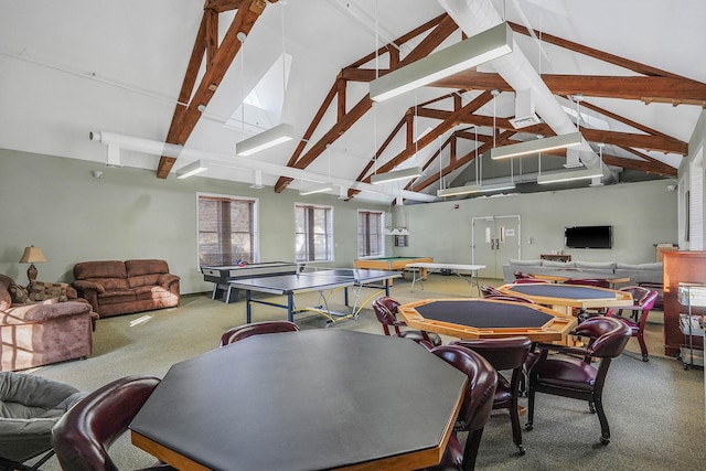 recreation room with beam ceiling, high vaulted ceiling, and carpet