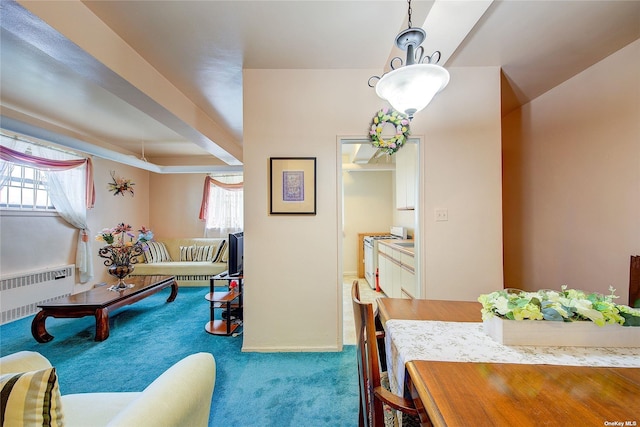 carpeted dining space with radiator heating unit