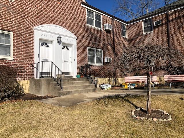 entrance to property featuring a yard