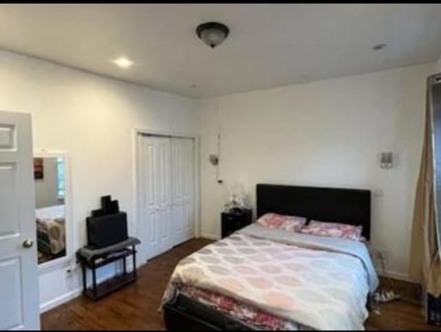 bedroom with dark hardwood / wood-style flooring