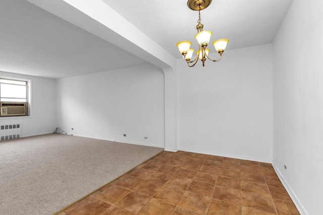 carpeted spare room with radiator heating unit, an inviting chandelier, and cooling unit