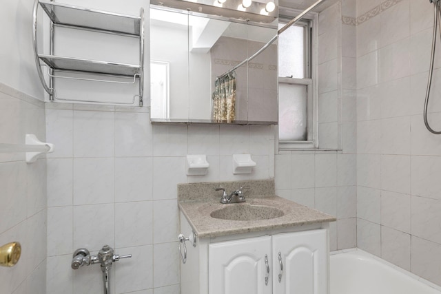 bathroom with tile walls, vanity, decorative backsplash, and shower / bath combo with shower curtain