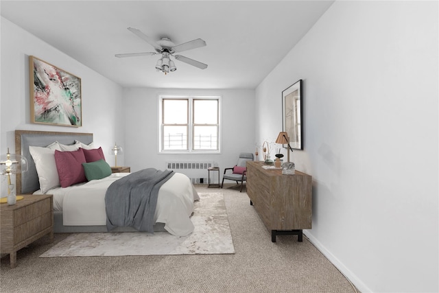 carpeted bedroom with ceiling fan and radiator