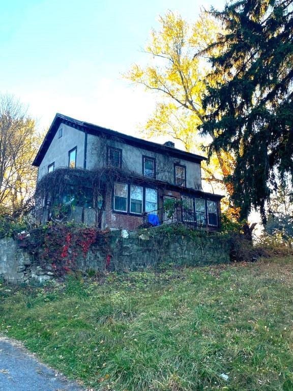 rear view of property featuring a yard