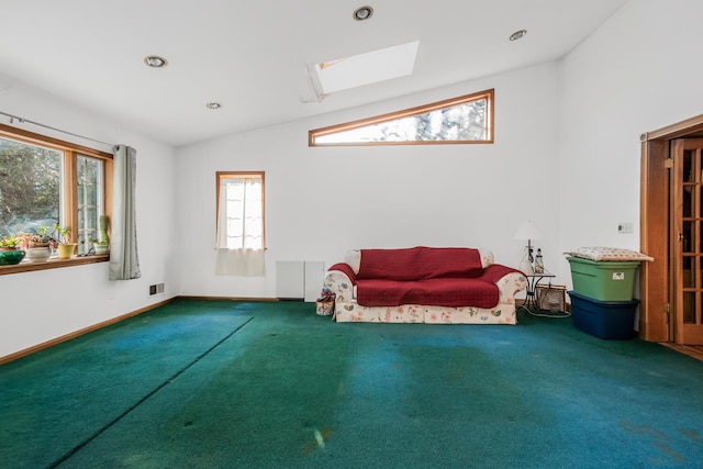 sitting room featuring carpet and vaulted ceiling with skylight