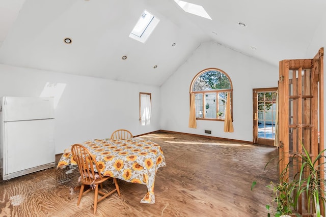 dining space featuring vaulted ceiling with skylight