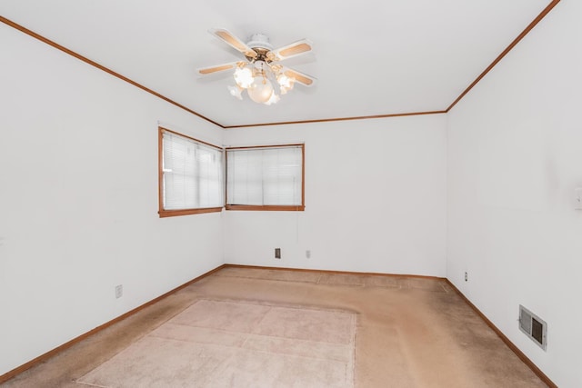 carpeted spare room with crown molding and ceiling fan