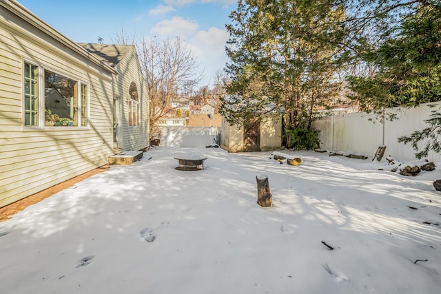 exterior space with a storage unit and a fire pit