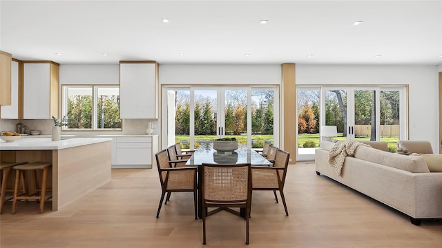 dining area featuring light hardwood / wood-style flooring and french doors