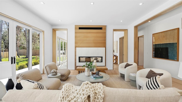 living room featuring light hardwood / wood-style floors and a multi sided fireplace