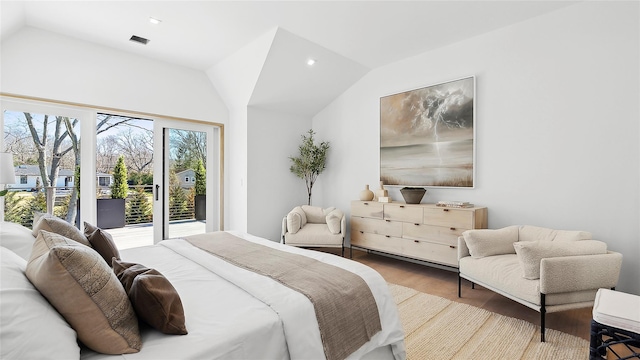 bedroom featuring access to outside, vaulted ceiling, and light wood-type flooring