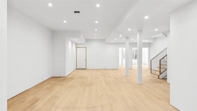 basement with light hardwood / wood-style flooring