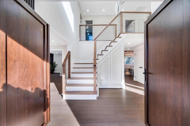 entrance foyer with a high ceiling and dark wood-type flooring