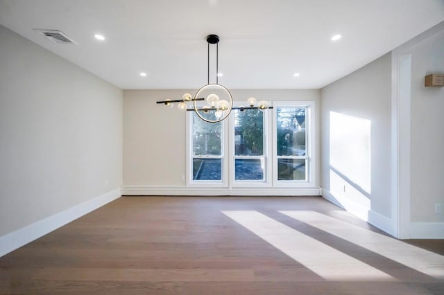 unfurnished dining area with an inviting chandelier and wood-type flooring