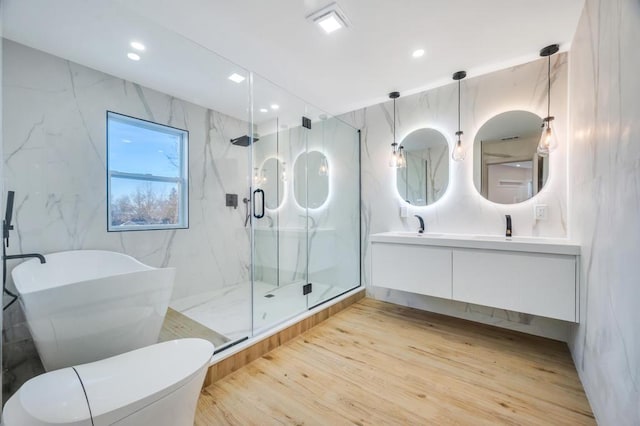 bathroom with vanity, separate shower and tub, and hardwood / wood-style floors