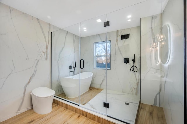 bathroom featuring tile walls, plus walk in shower, and toilet