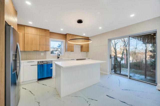 kitchen featuring refrigerator with ice dispenser, sink, dishwasher, white cabinets, and a kitchen island