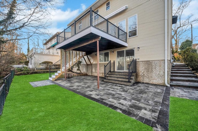 rear view of property with a yard and a patio