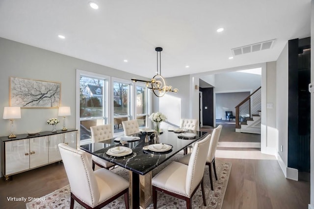 dining space with a chandelier and dark hardwood / wood-style flooring