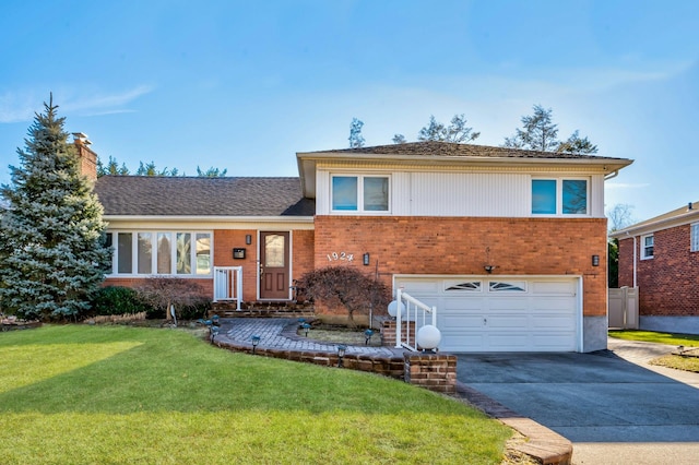 split level home featuring a garage and a front lawn