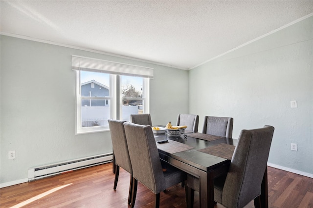 dining area featuring a textured ceiling, a baseboard radiator, ornamental molding, and wood-type flooring