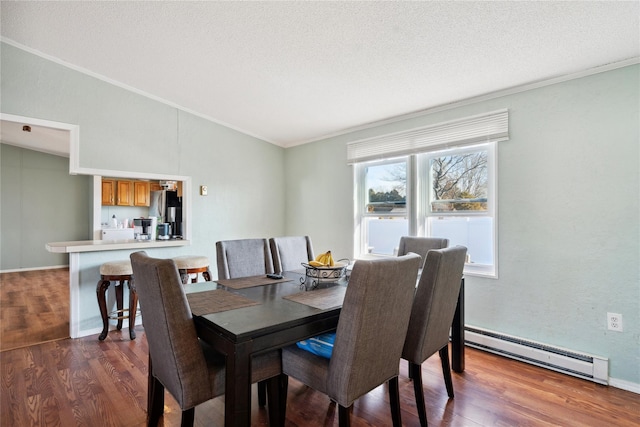 dining space featuring a baseboard heating unit, ornamental molding, dark hardwood / wood-style floors, and a textured ceiling