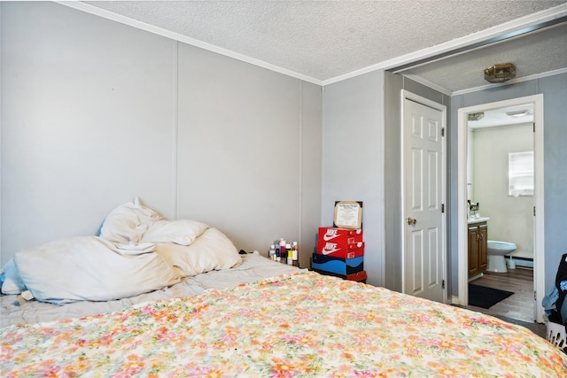 bedroom featuring hardwood / wood-style floors, ensuite bath, a baseboard heating unit, crown molding, and a textured ceiling