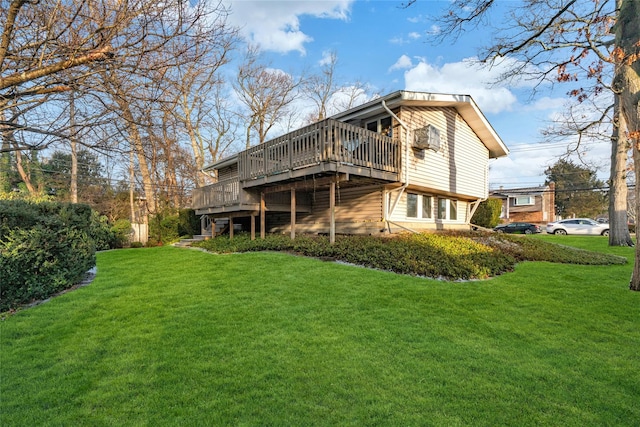 rear view of house with a lawn and a deck